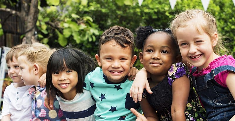 Children smiling together outdoors